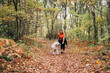 © Daniel Gonzalez/Stocksy - A beautiful woman has fun with her dog in autumn