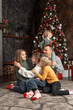 © somemeans - Big happy family at home, traditional xmas decorated living room. Mom dad and children near Christmas tree. Xmas holiday