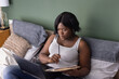 © Anna Berkut/Stocksy - focused woman working from home, thinking, problem solving