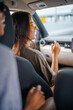 © Jovo Jovanovic/Stocksy - Happy Asian woman sharing laugh with friends in car