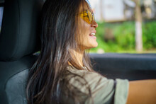 Young Asian Woman With Long Black Hair In Car With Sunglasses On