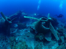 Scuba Divers Exploring Airplane Wreck Underwater Taking Photos Of C47