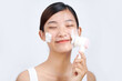 © Marc Tran/Stocksy - The girl cleans the skin of the face with a brush and foam for washing