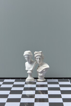 Antique White Plaster Sculptures On Chessboard.