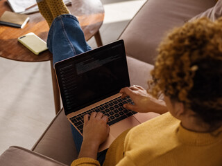 Software developer working on sofa near table