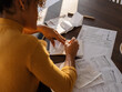 © Milles Studio/Stocksy - Crop woman making notes during work with bills