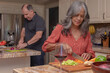 © Jordana Sheara/Stocksy - mature couple cooking together