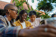 © Jovo Jovanovic/Stocksy - Three friends reading menu together at outdoor restaurant