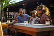 © Jovo Jovanovic/Stocksy - Happy diverse group of friends at a restaurant