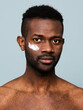© ohlamour studio/Stocksy - Man with smudge of moisturizing lotion in face