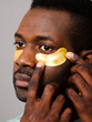 © ohlamour studio/Stocksy - Man applying collagen eye patch