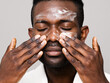 © ohlamour studio/Stocksy - Man using face wash