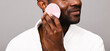 © ohlamour studio/Stocksy - Cropped close up of man using facial pad brush