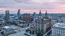 Aerial View With Royal Liver Building In Liverpool Docklands In The City Center, First Rays At Sunrise