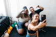 © Studio Firma/Stocksy - People Taking Selfie in Gym