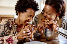 Laughing Women Eating Croissants
