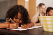 © Aleksandra Jankovic/Stocksy - Little Girl Sitting At The Table And Writing On A Piece Of Paper