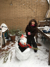 UGC Kid In Winter Outfit Playing With Snowman In Home Terrace