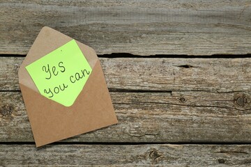 Wall Mural - Envelope and phrase Yes You Can on wooden table, top view with space for text. Motivational quote