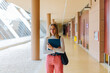 © VICTOR TORRES/Stocksy - Pretty young girl holding folder over brown wall