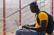 © VICTOR TORRES/Stocksy - Young man with laptop on stairs