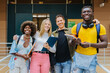 © VICTOR TORRES/Stocksy - Cheerful multiethnic students standing in university hall