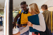 © VICTOR TORRES/Stocksy - Diverse friends looking at university posters on a bulletin board