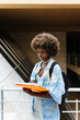 © VICTOR TORRES/Stocksy - Serious black woman reading book at university