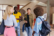 © VICTOR TORRES/Stocksy - Group of diverse friends with backpacks at university