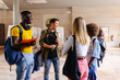 © VICTOR TORRES/Stocksy - Group of diverse friends with backpacks at university
