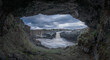 © Elena Saurius & Dani Rex/Stocksy - View of Aldeyjarfoss Waterfall from a cave under cloudy sky, Iceland
