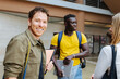 © VICTOR TORRES/Stocksy - Cheerful multiethnic students at university hall