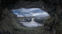 View Of Aldeyjarfoss Waterfall From A Cave Under Cloudy Sky, Iceland