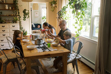 Grandparents Having Dinner With Their Grandchildren