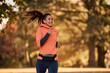 © Drazen - Motivated female athlete jogging in park.