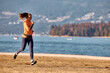 © Drazen - Happy athletic woman jogging along the quay.