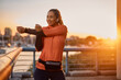 © Drazen - Young female athlete warming up for sports training at sunset.