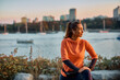 © Drazen - Young female athlete doing stretching exercises on quay.