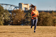 © Drazen - Full length of happy athletic woman running in park.