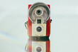 © Carter Wright/Stocksy - Vintage flash film camera arranged on a mirror with lens flare