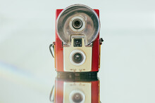 Vintage Flash Film Camera Arranged On A Mirror With Lens Flare