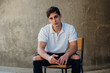 © Ivona Zivulj/Stocksy - Cool Young Male Model Sitting on Chair