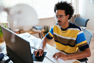 Serious mixed race man using computer