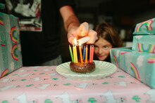 Man Lights Candles On Birthday Cake