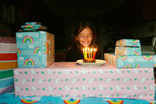 Girl Sits In Front Of Candles On Donut For Her Birthday