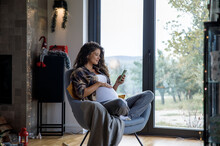 Pregnant Woman Relaxing At Home During Holidays