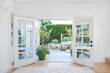 © Trinette Reed/Stocksy - French doors to patio in cottage home