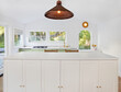 © Trinette Reed/Stocksy - Modern kitchen and kitchen island in small cottage home