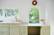© Trinette Reed/Stocksy - Desk in modern cute cottage kitchen