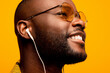 © VICTOR TORRES/Stocksy - Cheerful black man in eyeglasses and earphones